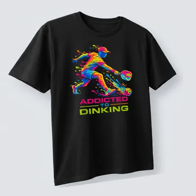 Colorful illustration of a pickleball player with dynamic splash art and text — printed on a unisex t-shirt (angled view)