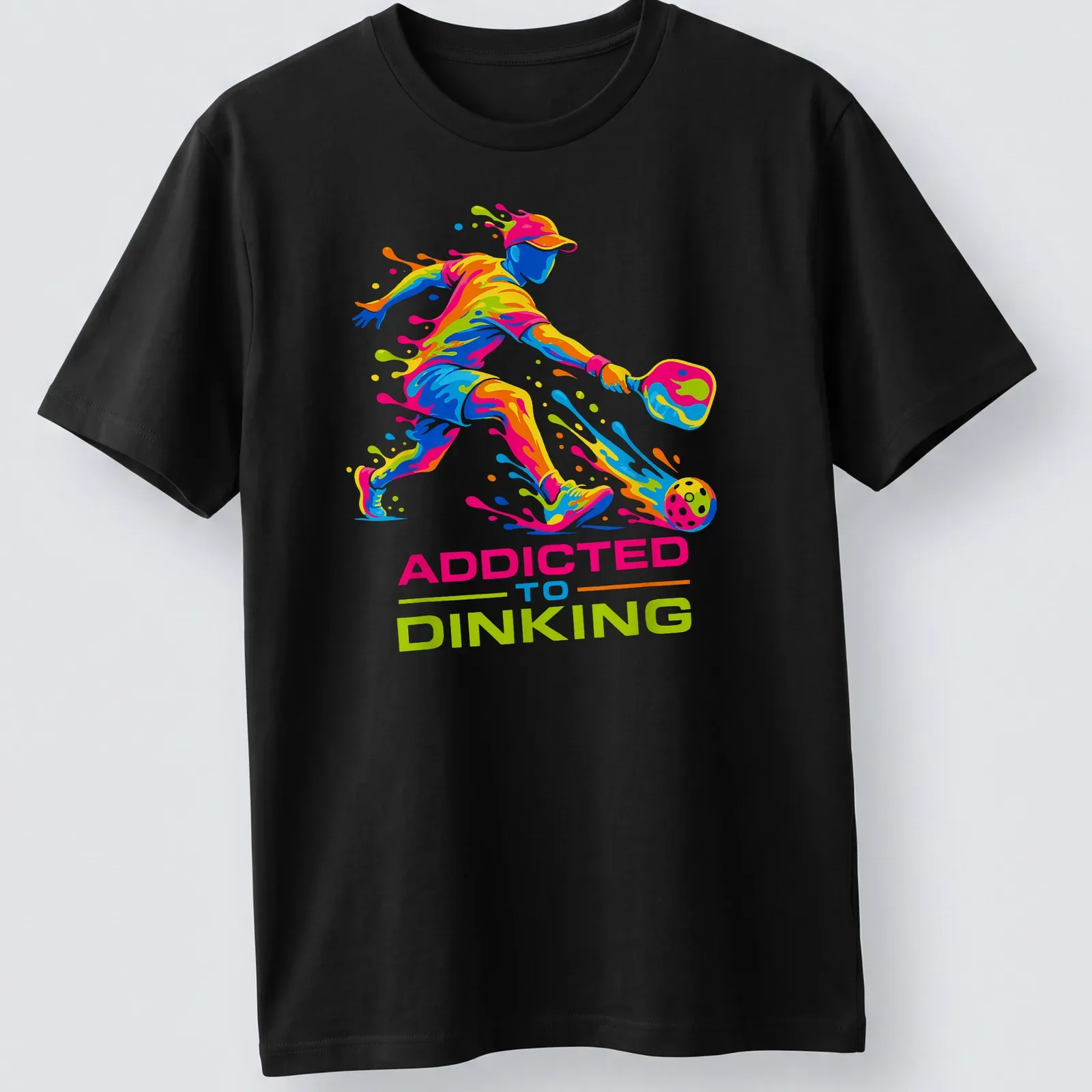 Colorful illustration of a pickleball player with dynamic splash art and text — printed on a unisex t-shirt