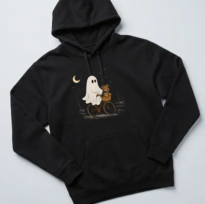 Cartoon Airedale Terrier ghost riding a bicycle in Halloween colors — printed on a unisex hoodie
