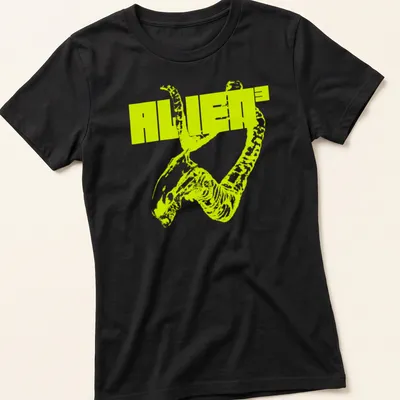 Bold graphic ALIEN³ t-shirt featuring an alien creature in neon yellow and black. — printed on a women's shirt