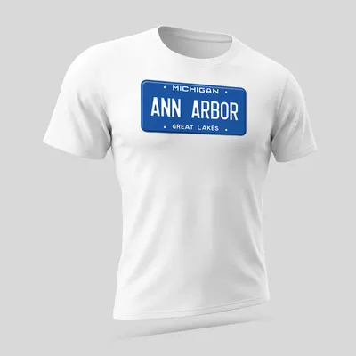 Vintage-style t-shirt featuring a Michigan license plate graphic in blue and white — printed on a unisex t-shirt (angled view)