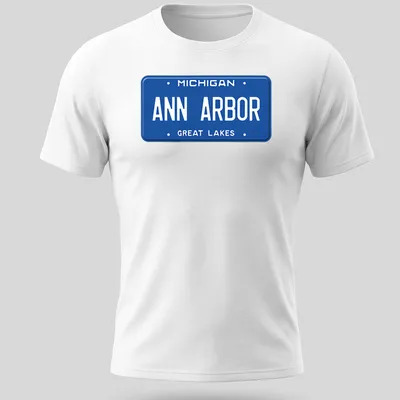 Vintage-style t-shirt featuring a Michigan license plate graphic in blue and white — printed on a unisex t-shirt