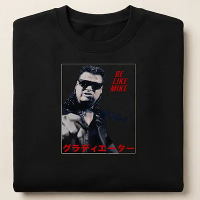 Bold graphic tee featuring wrestler with text 'BE LIKE MIKE グラディエーター' in red, black, and white. — printed on a unisex sweatshirt