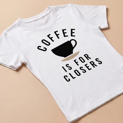 Coffee-themed t-shirt with bold text 'COFFEE IS FOR CLOSERS' above a graphic of a coffee cup — printed on a women's shirt