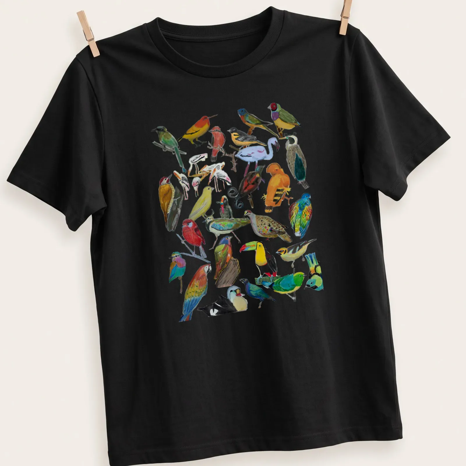 Vibrant illustration of various birds in multiple colors on a — printed on a unisex t-shirt