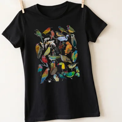 Vibrant illustration of various birds in multiple colors on a — printed on a women's shirt