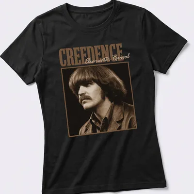 Vintage style t-shirt featuring the text 'CREEDENCE Clearwater Revival' in brown and beige — printed on a women's shirt