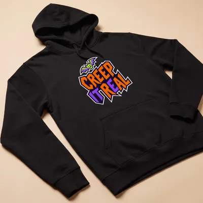 Cartoon bat graphic with Creep It Real text in Halloween colors — printed on a unisex hoodie