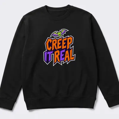 Cartoon bat graphic with Creep It Real text in Halloween colors — printed on a unisex sweatshirt