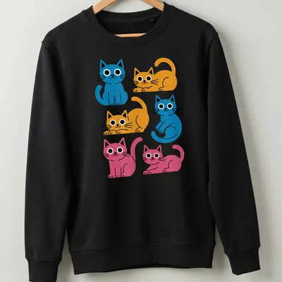 Kawaii-style shirt featuring colorful cartoon cats in blue, orange, and pink — printed on a unisex sweatshirt