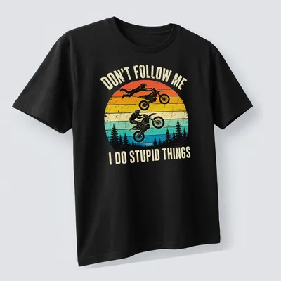 Retro distressed motocross t-shirt featuring riders and humorous text — printed on a unisex t-shirt (angled view)