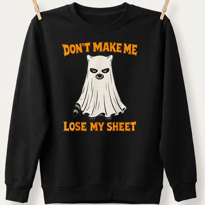 Cartoon ghost raccoon with humorous text about losing a sheet in orange, black, and white — printed on a unisex sweatshirt