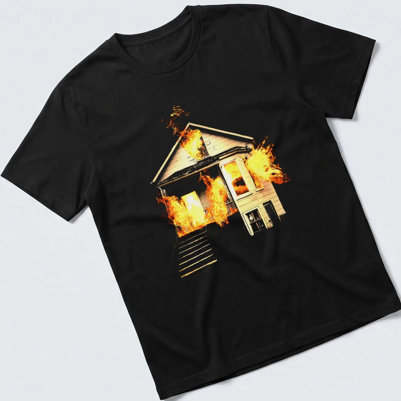 Illustrative design of a house on fire in orange, yellow, and black — printed on a unisex t-shirt