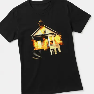 Illustrative design of a house on fire in orange, yellow, and black — printed on a women's shirt