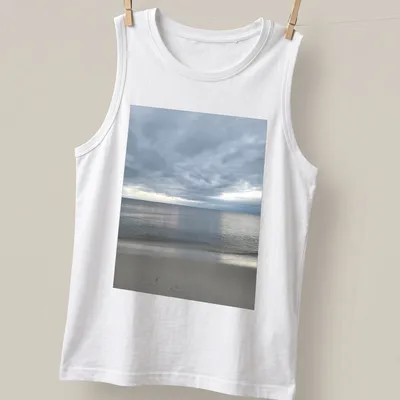Photographic print of a dramatic bay view in gray, blue, and beige hues — printed on a tank top