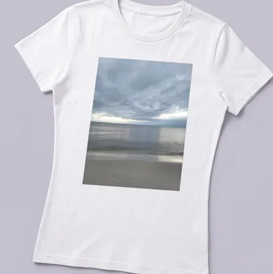 Photographic print of a dramatic bay view in gray, blue, and beige hues — printed on a women's shirt