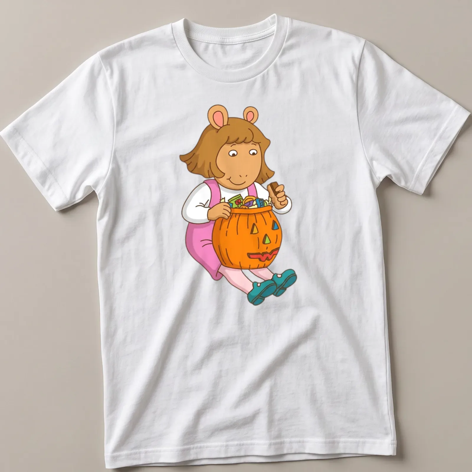 Cartoon image of a girl with a pumpkin candy bucket and colorful text — printed on a unisex t-shirt