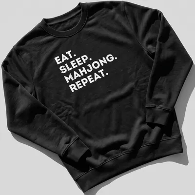 Bold typography shirt with 'EAT. SLEEP. MAHJONG. REPEAT.' text in white — printed on a unisex sweatshirt