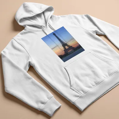 Photographic print of the Eiffel Tower at sunset in blue, orange, pink, and gray. — printed on a unisex hoodie