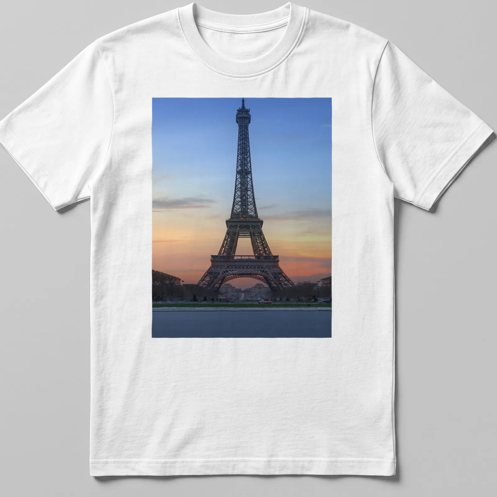 Photographic print of the Eiffel Tower at sunset in blue, orange, pink, and gray. — printed on a unisex t-shirt