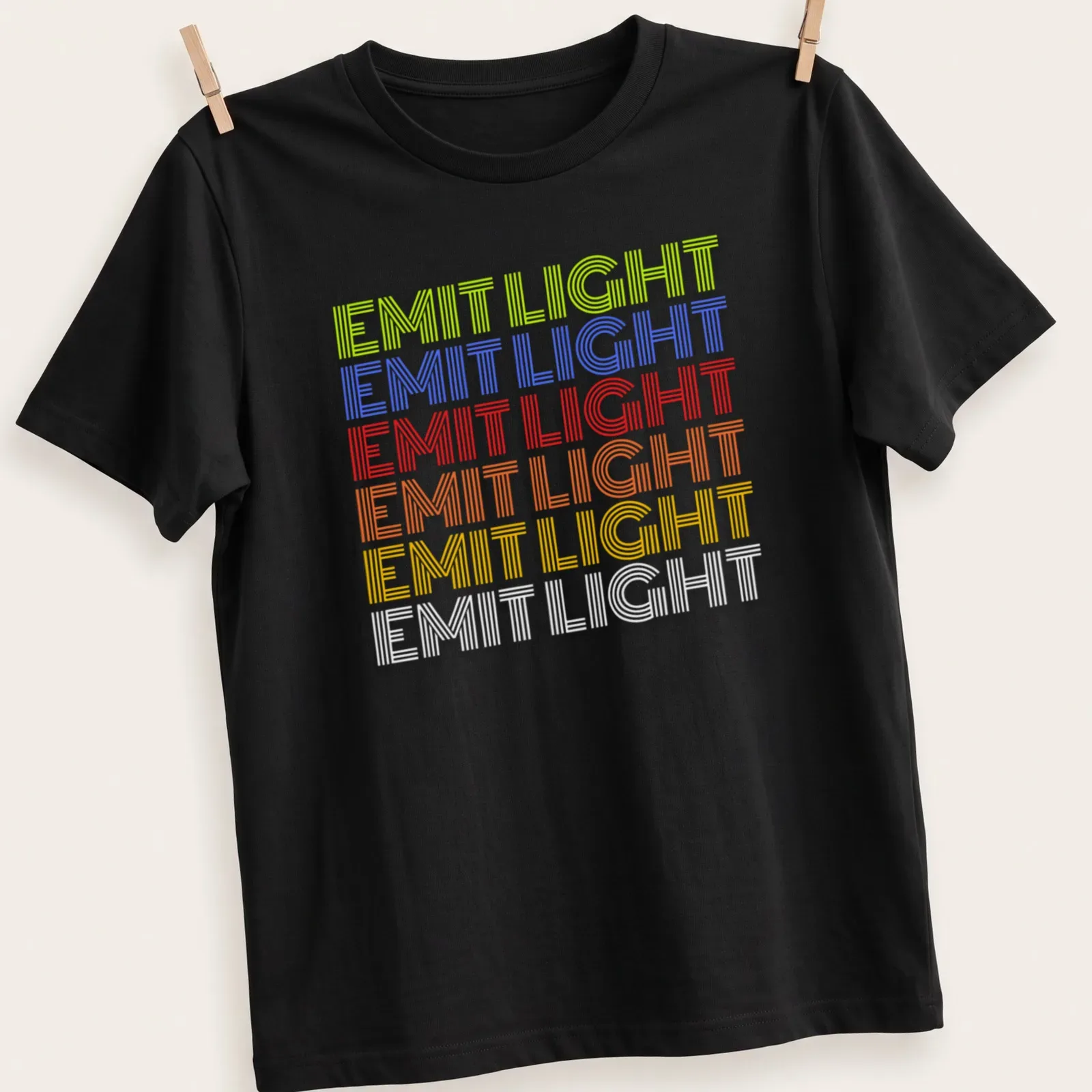 Retro shirt with stacked text reading 'EMIT LIGHT' in vibrant colors — printed on a unisex t-shirt