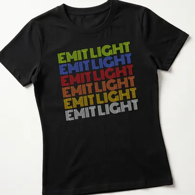 Retro shirt with stacked text reading 'EMIT LIGHT' in vibrant colors — printed on a women's shirt
