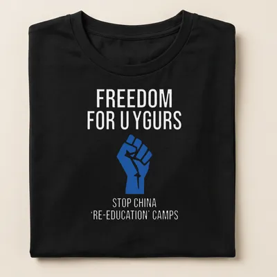 Bold graphic T-shirt with text calling for Uyghur freedom and a raised fist — printed on a women's shirt