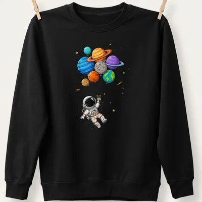 Cartoon astronaut in space holding colorful planet-shaped balloons — printed on a unisex sweatshirt