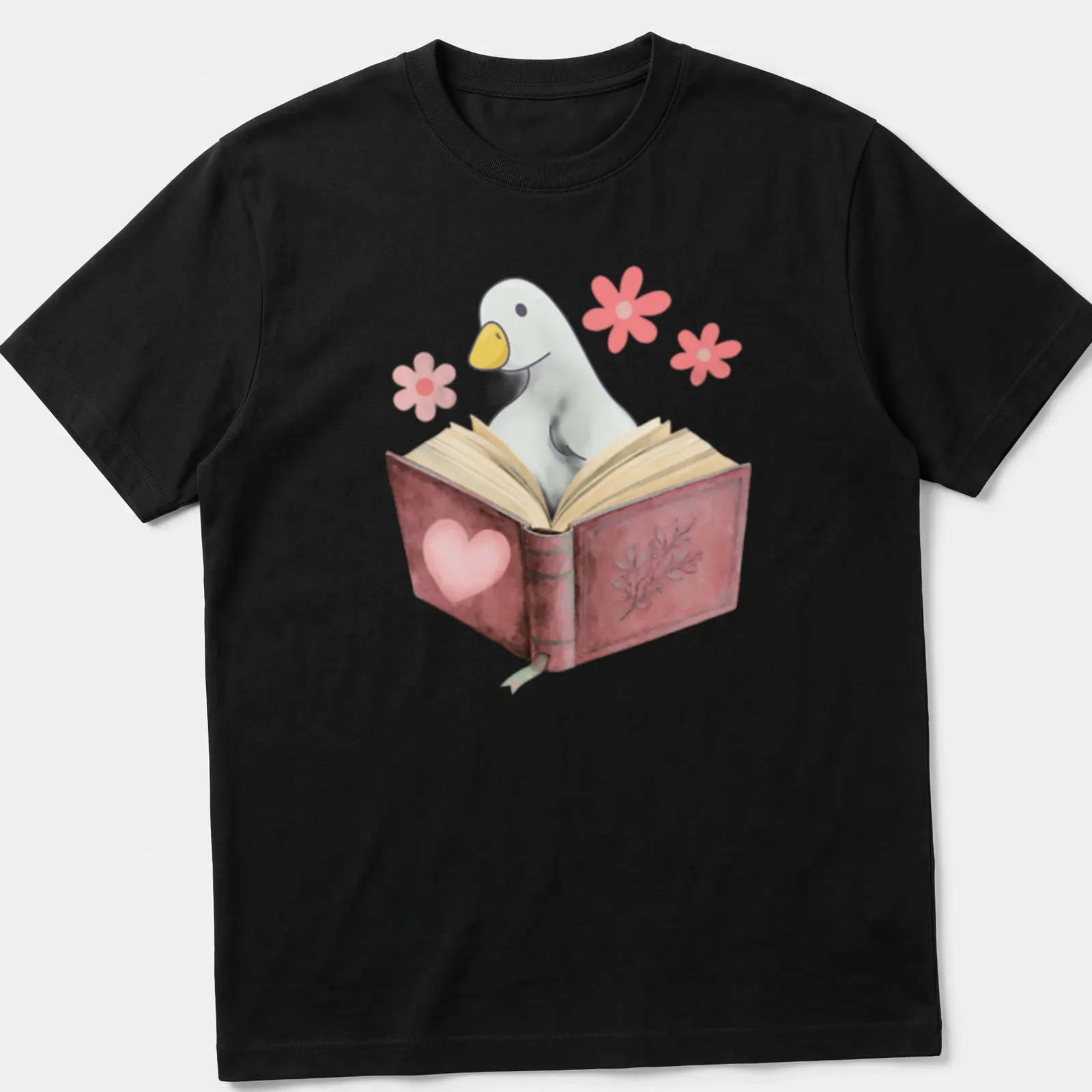 Kawaii illustration of a goose reading a book with colorful flowers — printed on a unisex t-shirt