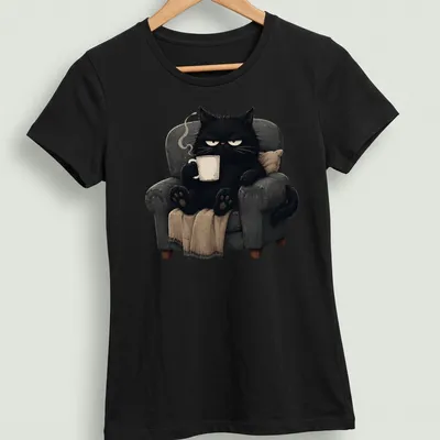 Kawaii illustration of a grumpy black cat holding a coffee mug — printed on a women's shirt