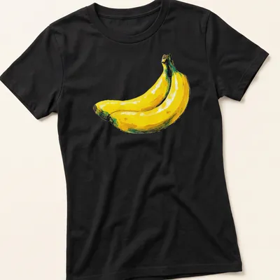 Hand drawn yellow bananas with green leaves on a white background — printed on a women's shirt