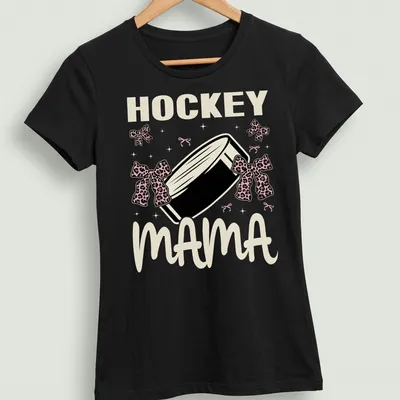 Hockey Mama t-shirt with leopard print bows around a hockey puck — printed on a women's shirt
