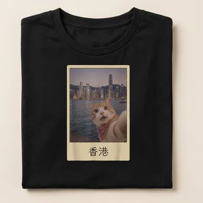 Orange tabby cat selfie with Hong Kong cityscape, colorful photographic print — printed on a women's shirt