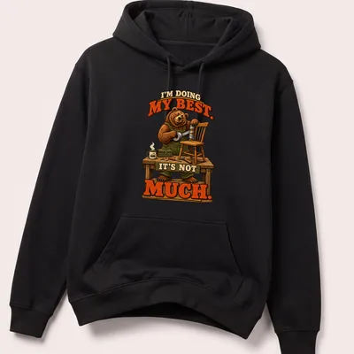 Bear illustration with the text 'I'm Doing My Best. It's Not Much.' in brown, green, and orange. — printed on a unisex hoodie