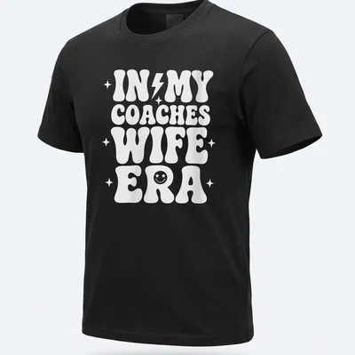 Bold typography t-shirt with IN MY COACHES WIFE ERA text in white