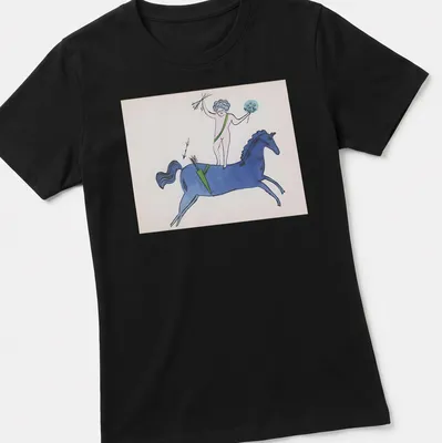 Playful illustration of a nude figure on a blue horse with garden text above. — printed on a women's shirt