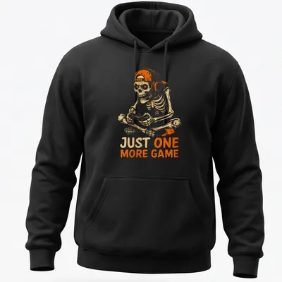 Cartoon skeleton playing video games with the text 'JUST ONE MORE GAME' in fun lettering. — printed on a unisex hoodie