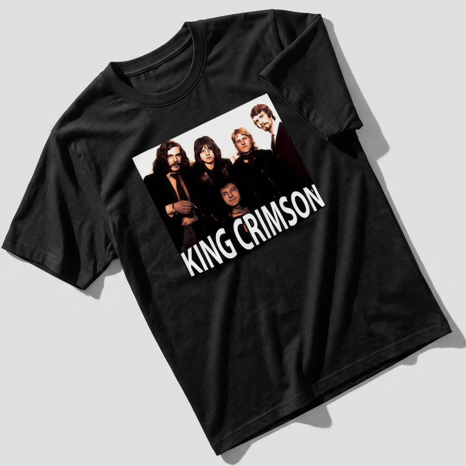 Vintage King Crimson T-shirt with bold lettering in black, white, brown, and beige — printed on a unisex t-shirt