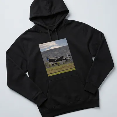 Photographic print of a Kittyhawk airplane taking off against a blue sky — printed on a unisex hoodie