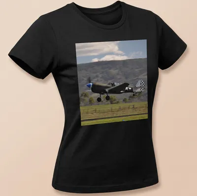 Photographic print of a Kittyhawk airplane taking off against a blue sky — printed on a women's shirt