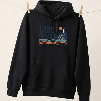 Retro lighthouse sunset illustration on Lake Ontario shirt with navy blue and orange colors. — printed on a unisex hoodie