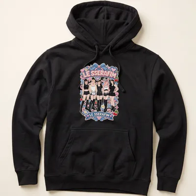 Colorful cartoon design featuring the text LE SSERAFIM and five members of the girl group — printed on a unisex hoodie