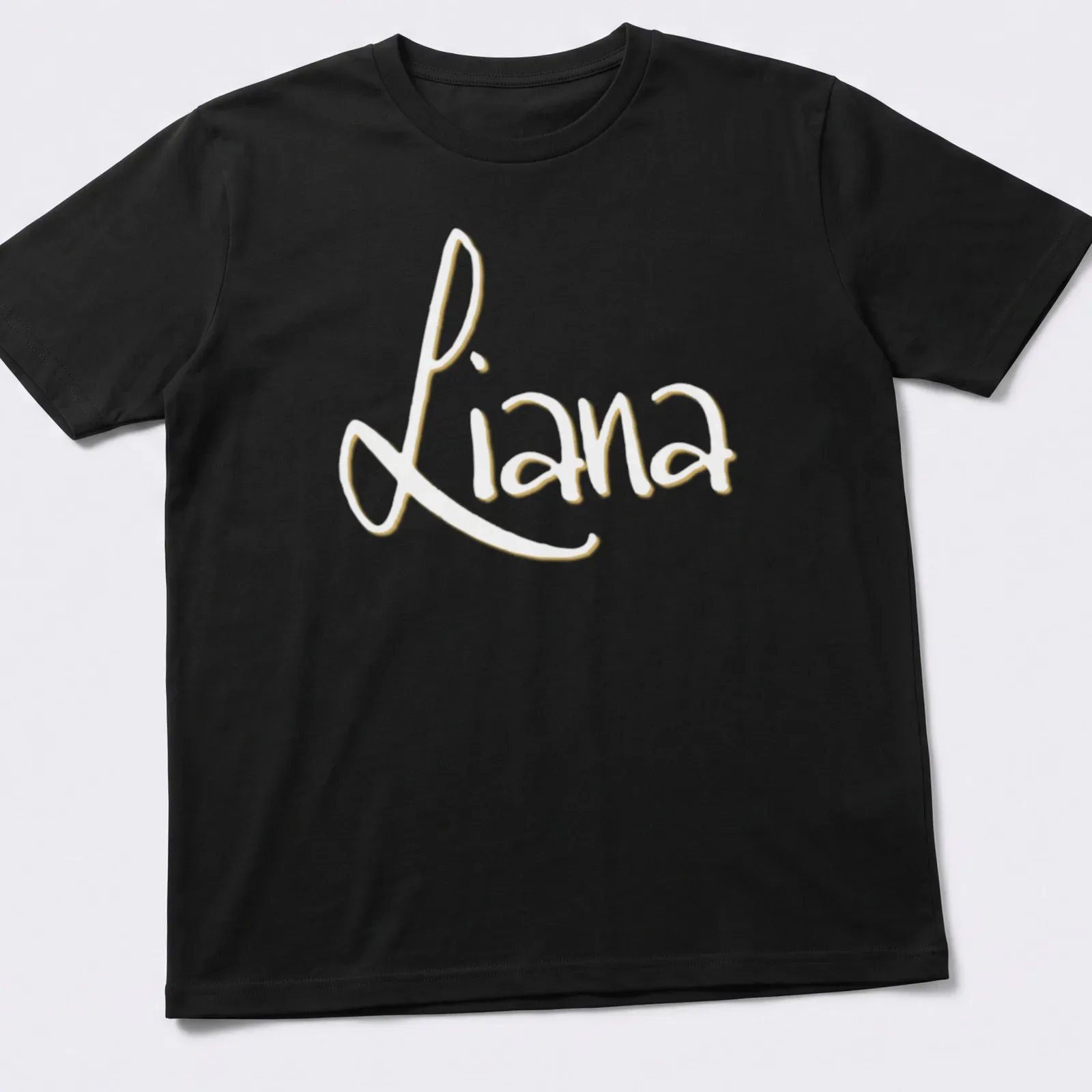 Personalized shirt featuring the name Liana in elegant gold script on white — printed on a unisex t-shirt