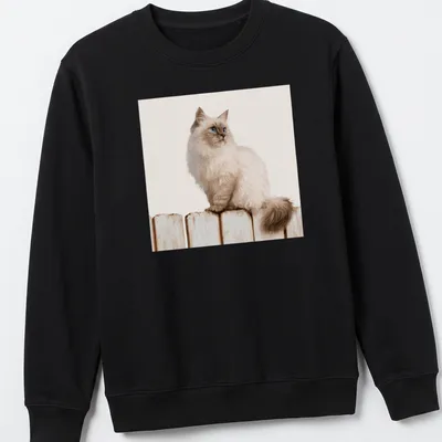 Realistic illustration of a Siamese cat sitting on a wooden fence against a blue sky. — printed on a unisex sweatshirt