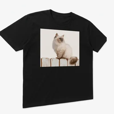 Realistic illustration of a Siamese cat sitting on a wooden fence against a blue sky. — printed on a unisex t-shirt (angled view)
