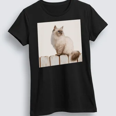 Realistic illustration of a Siamese cat sitting on a wooden fence against a blue sky. — printed on a women's shirt
