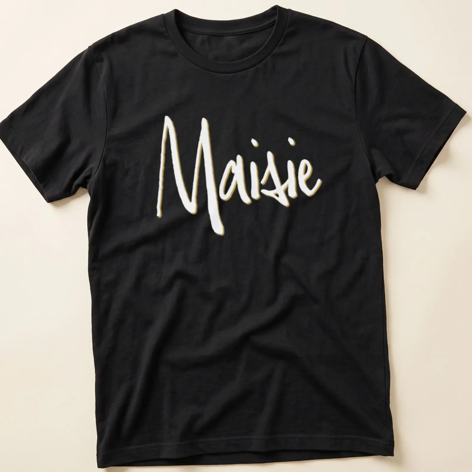 Handwritten design featuring the name Maisie in light yellow — printed on a unisex t-shirt