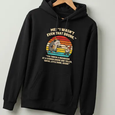 Playful cartoon of a possum and garden gnome with humorous text about mushrooms — printed on a unisex hoodie