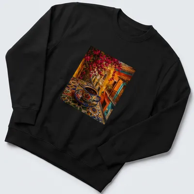 Colorful folk art coffee cup on a vibrant table in blue, orange, pink, yellow, and green — printed on a unisex sweatshirt