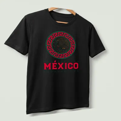 Eagle graphic with the word MÉXICO in bold, traditional colors of red, green, gold, and white. — printed on a unisex t-shirt (angled view)